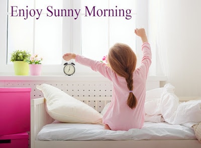 A nice child girl enjoys sunny morning. Good morning at home. Child girl wakes up from sleep.