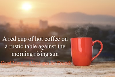 A red cup of hot coffee on a rustic table against the morning rising sun