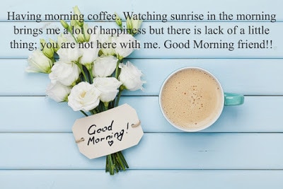 Coffee mug with white flowers and notes good morning on blue rustic table from above. Beautiful breakfast. Flat lay.