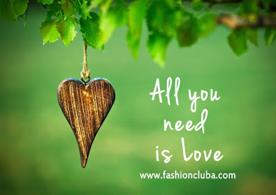 All-you-need-is-love-inspirational-quote-on-natural-green-background-with-wooden-shape-of-heart.