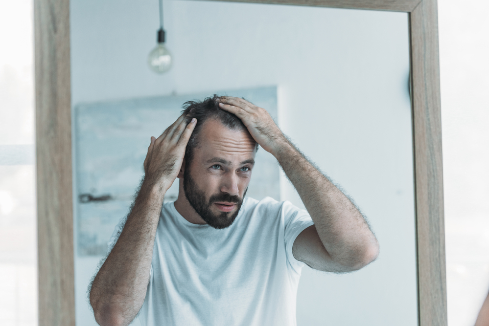 man looking to mirror